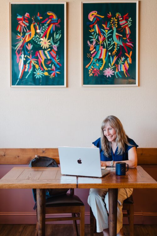 a CC Plus Masters Program student working on her laptop