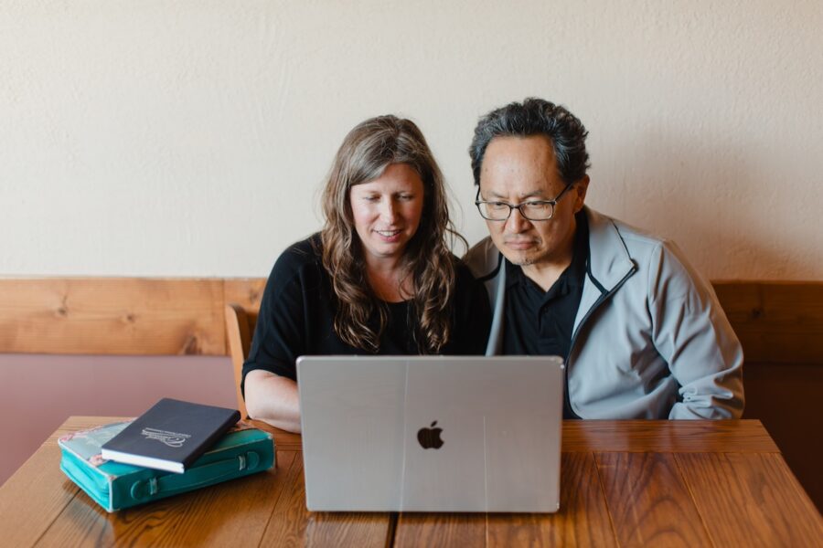 two parents taking a CC Plus Master's program course online on a laptop